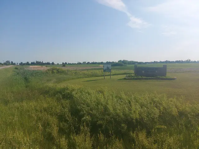 Town entrance sign and fields